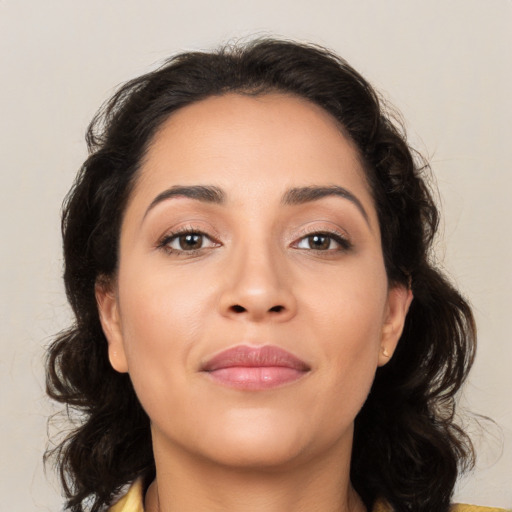 Joyful latino young-adult female with medium  brown hair and brown eyes