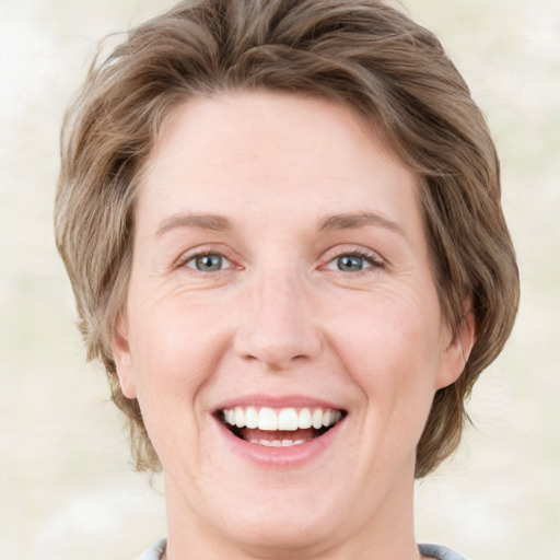 Joyful white young-adult female with medium  brown hair and green eyes