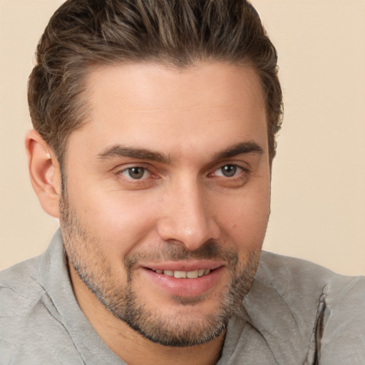 Joyful white young-adult male with short  brown hair and brown eyes