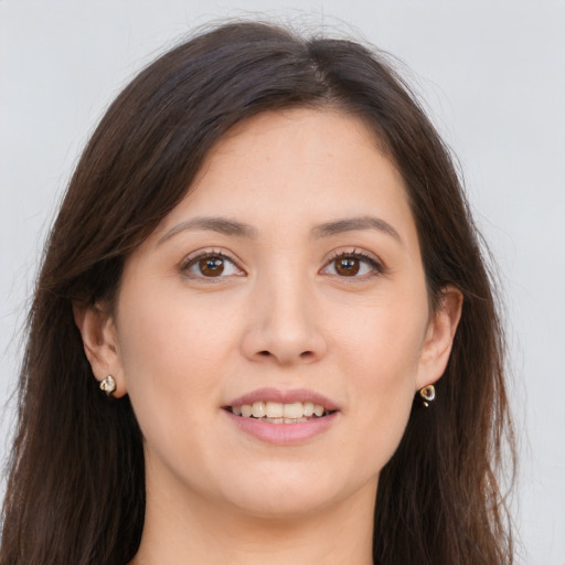 Joyful white young-adult female with long  brown hair and brown eyes
