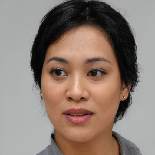 Joyful asian young-adult female with medium  black hair and brown eyes