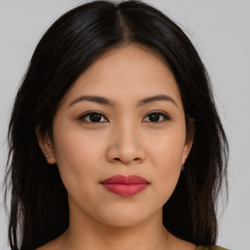 Joyful asian young-adult female with long  black hair and brown eyes