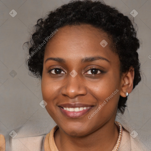 Joyful black young-adult female with long  brown hair and brown eyes