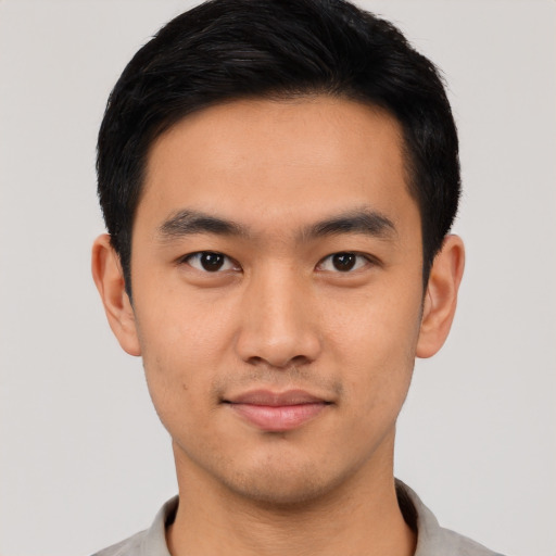 Joyful asian young-adult male with short  black hair and brown eyes