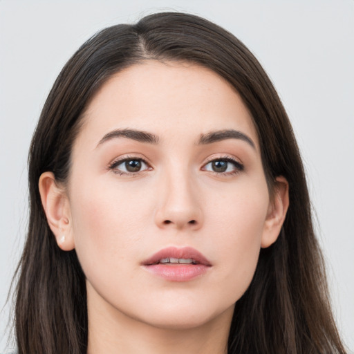 Neutral white young-adult female with long  brown hair and brown eyes