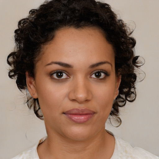 Joyful black young-adult female with medium  brown hair and brown eyes