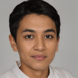 Joyful latino young-adult male with short  brown hair and brown eyes