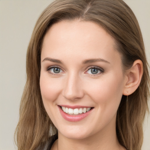 Joyful white young-adult female with long  brown hair and blue eyes