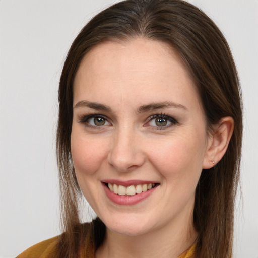 Joyful white young-adult female with long  brown hair and blue eyes