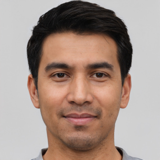 Joyful asian young-adult male with short  black hair and brown eyes