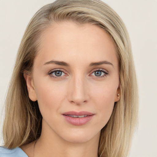 Joyful white young-adult female with long  brown hair and blue eyes