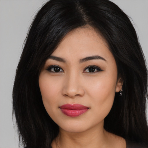 Joyful latino young-adult female with long  black hair and brown eyes
