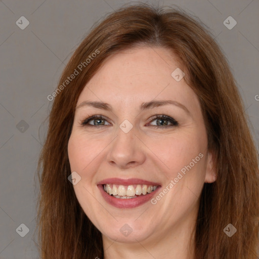 Joyful white adult female with long  brown hair and brown eyes