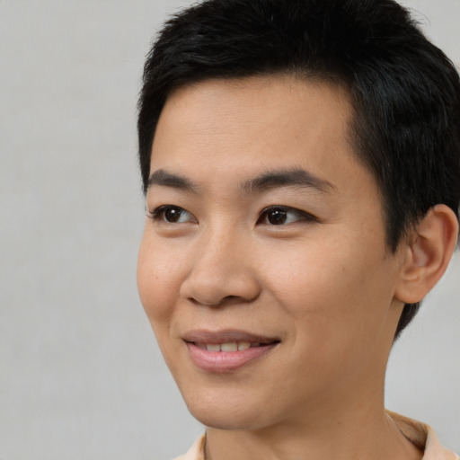 Joyful asian young-adult male with short  black hair and brown eyes