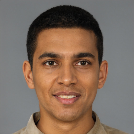 Joyful latino young-adult male with short  brown hair and brown eyes