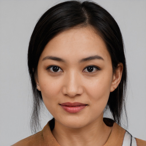 Joyful latino young-adult female with medium  black hair and brown eyes