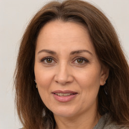 Joyful white adult female with long  brown hair and brown eyes