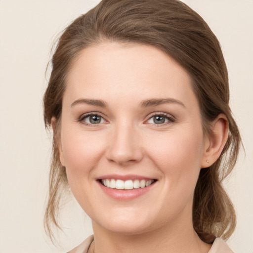 Joyful white young-adult female with medium  brown hair and green eyes