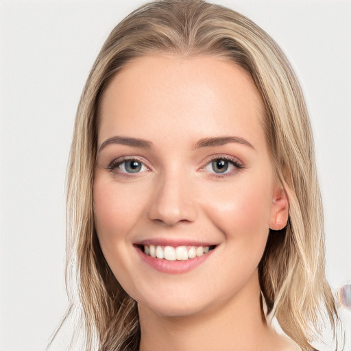 Joyful white young-adult female with long  brown hair and blue eyes