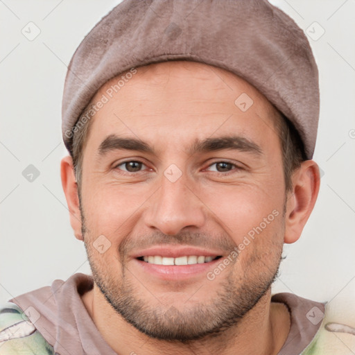 Joyful white young-adult male with short  brown hair and brown eyes