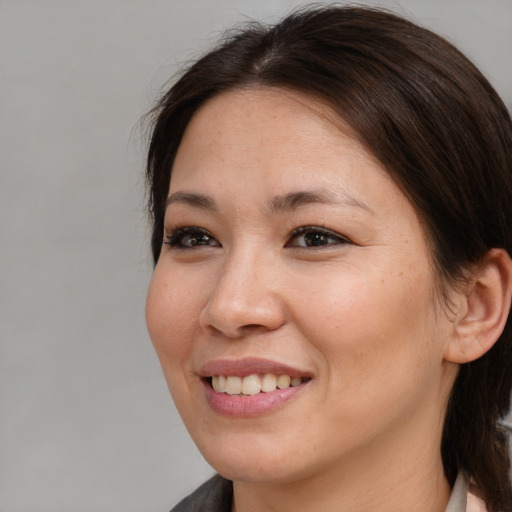 Joyful white young-adult female with medium  brown hair and brown eyes