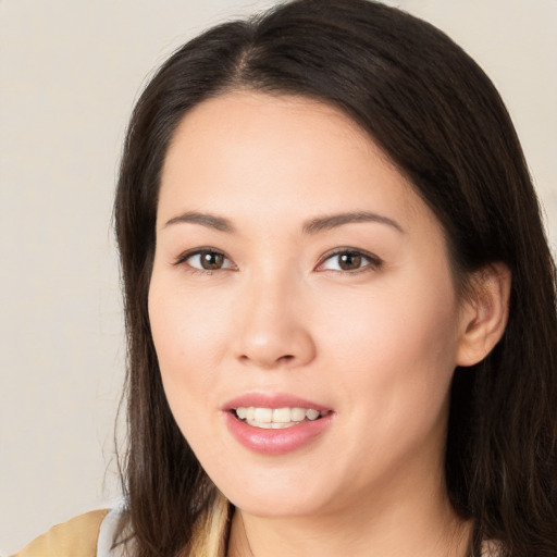 Joyful asian young-adult female with long  brown hair and brown eyes