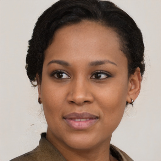 Joyful black young-adult female with medium  brown hair and brown eyes