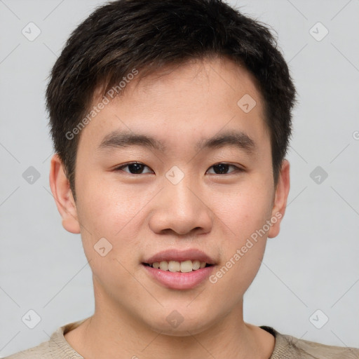 Joyful asian young-adult male with short  brown hair and brown eyes