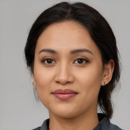 Joyful latino young-adult female with medium  brown hair and brown eyes