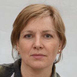 Joyful white adult female with medium  brown hair and grey eyes