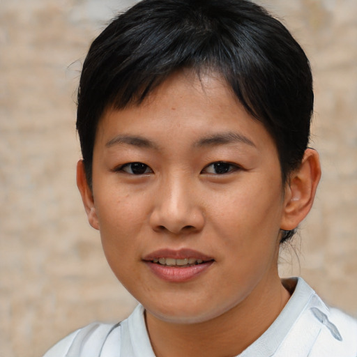 Joyful asian young-adult female with short  brown hair and brown eyes