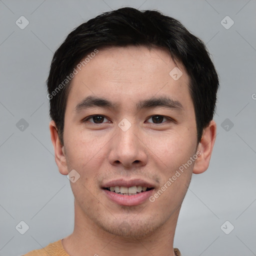 Joyful asian young-adult male with short  brown hair and brown eyes