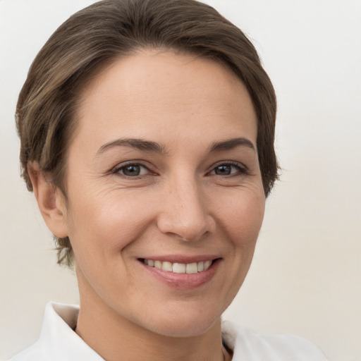 Joyful white young-adult female with short  brown hair and brown eyes