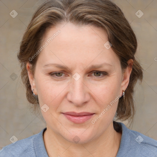 Joyful white adult female with medium  brown hair and grey eyes