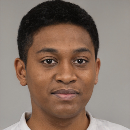 Joyful black young-adult male with short  brown hair and brown eyes