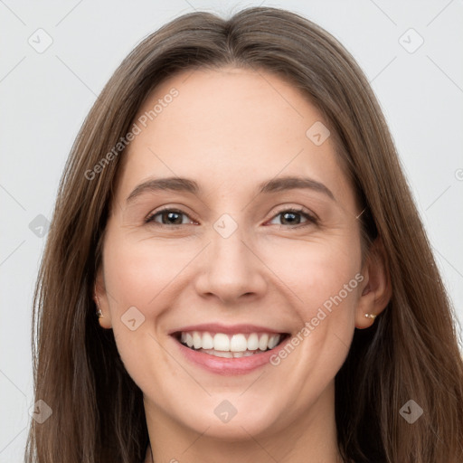 Joyful white young-adult female with long  brown hair and grey eyes