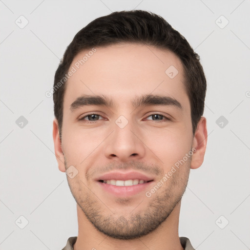 Joyful white young-adult male with short  black hair and brown eyes