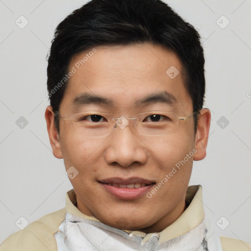 Joyful asian young-adult male with short  black hair and brown eyes