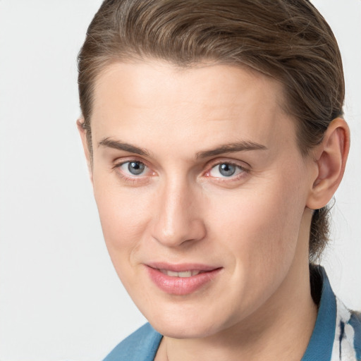 Joyful white young-adult female with medium  brown hair and grey eyes