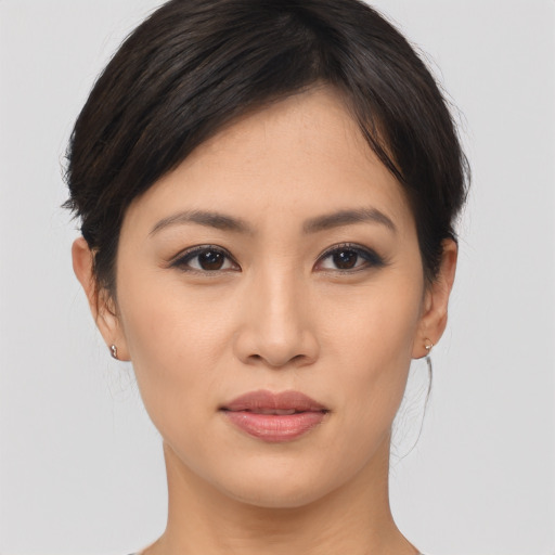 Joyful asian young-adult female with medium  brown hair and brown eyes