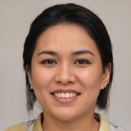 Joyful asian young-adult female with medium  brown hair and brown eyes