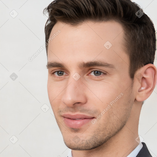 Joyful white young-adult male with short  brown hair and brown eyes