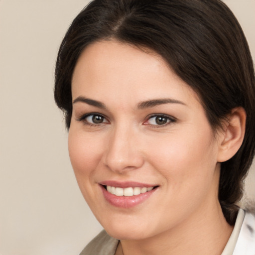 Joyful white young-adult female with medium  brown hair and brown eyes