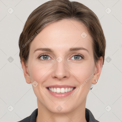 Joyful white young-adult female with short  brown hair and grey eyes