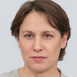 Joyful white adult female with medium  brown hair and grey eyes