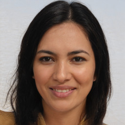 Joyful latino young-adult female with long  brown hair and brown eyes