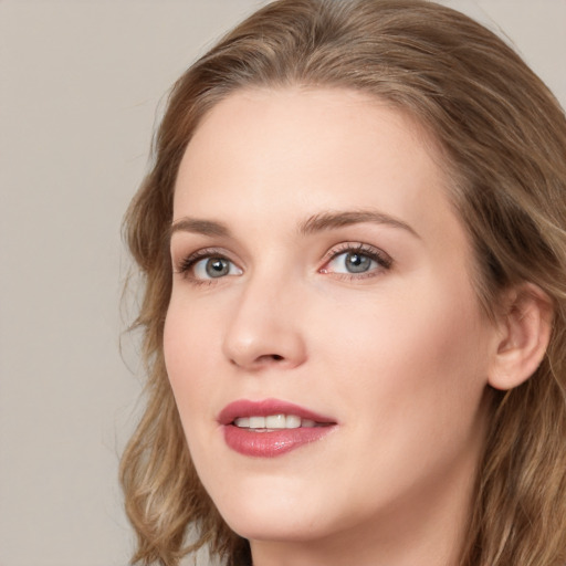 Joyful white young-adult female with long  brown hair and blue eyes