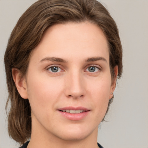 Joyful white young-adult female with medium  brown hair and grey eyes