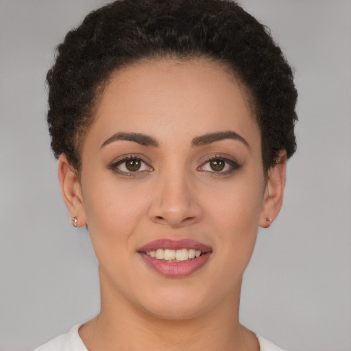 Joyful latino young-adult female with short  brown hair and brown eyes