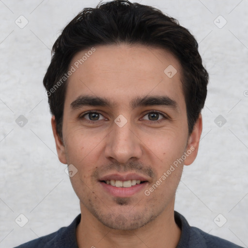 Joyful white young-adult male with short  black hair and brown eyes